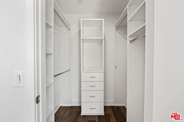a view of walk in closet with cabinet