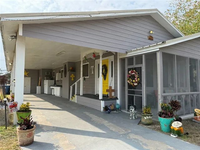 a front view of a house with outdoor seating