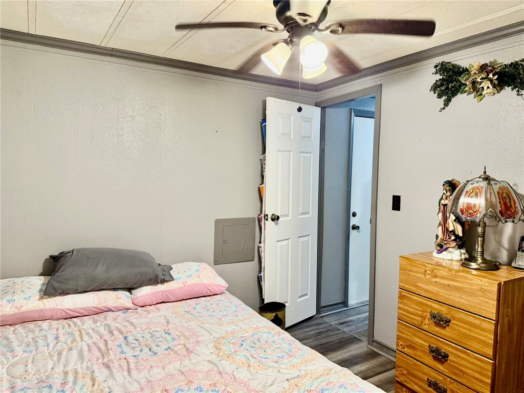 508 East Thornton Street Three Rivers, TX 78071 - Photo 12 of 17 a bedroom with a bed and a chandelier