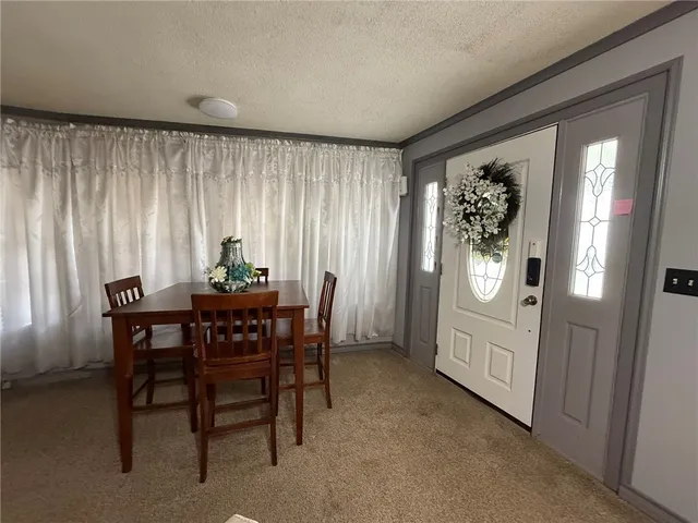 a view of a dining room with furniture and window