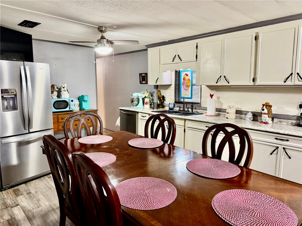508 East Thornton Street Three Rivers, TX 78071 - Photo 7 of 17 a kitchen with stainless steel appliances granite countertop a dining table and chairs