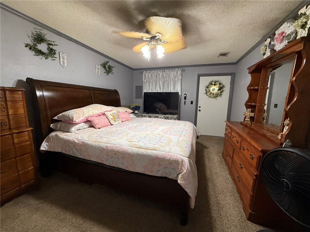 508 East Thornton Street Three Rivers, TX 78071 - Photo 9 of 17 a bedroom with a bed and a chandelier