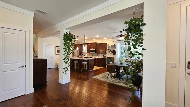 a living room with furniture and a potted plant