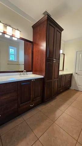 a bathroom with a double vanity sink and a mirror