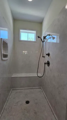 a bathroom with a glass shower door