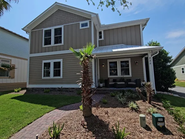 a front view of a house with garden