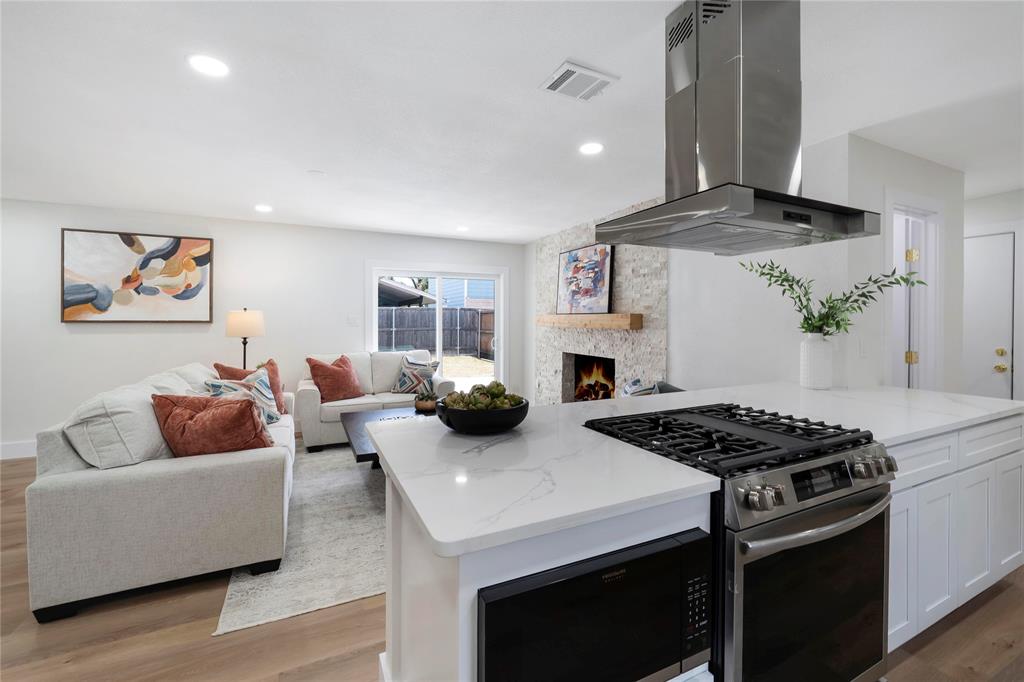 10416 Church Road Dallas, TX 75238 - Photo 15 of 36 a living room with furniture and a fireplace