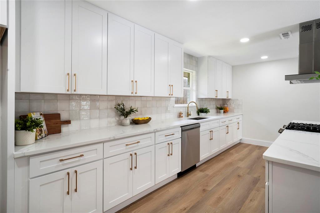 10416 Church Road Dallas, TX 75238 - Photo 18 of 36 a kitchen with cabinets stainless steel appliances a sink a counter top space and cabinets