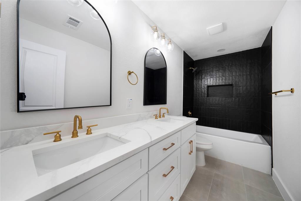 10416 Church Road Dallas, TX 75238 - Photo 20 of 36 a bathroom with a sink a toilet and shower