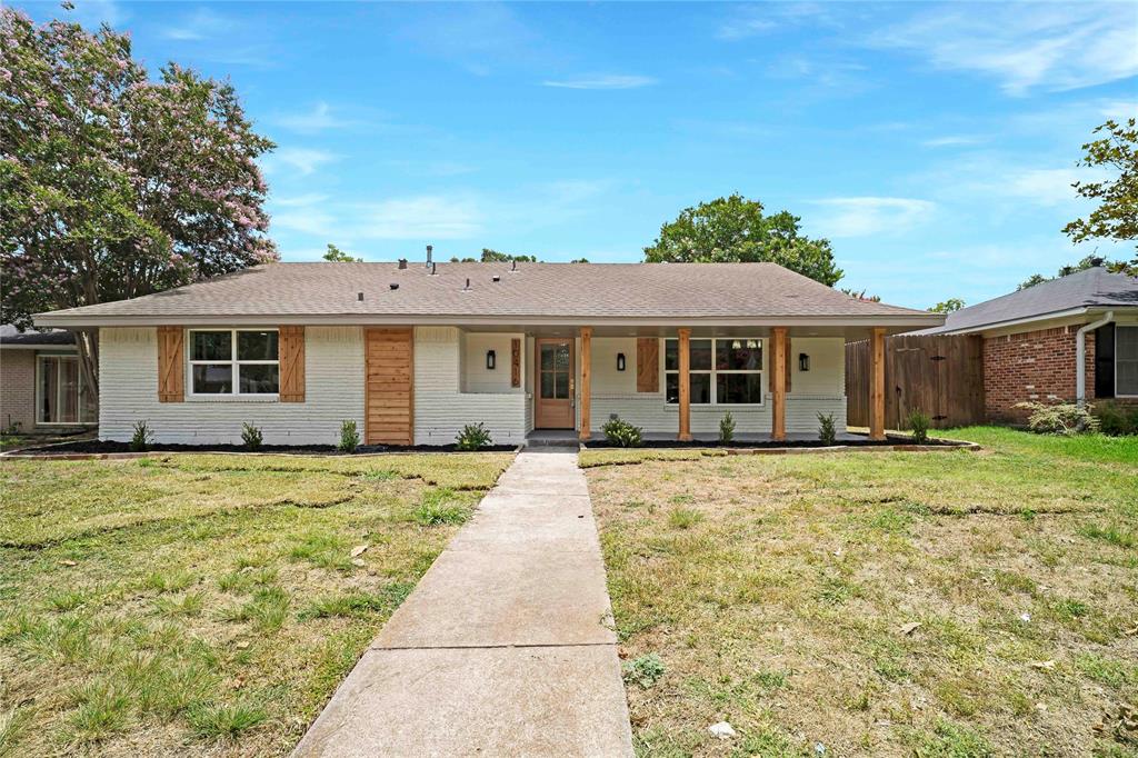 10416 Church Road Dallas, TX 75238 - Photo 2 of 36 a front view of a house with a garden