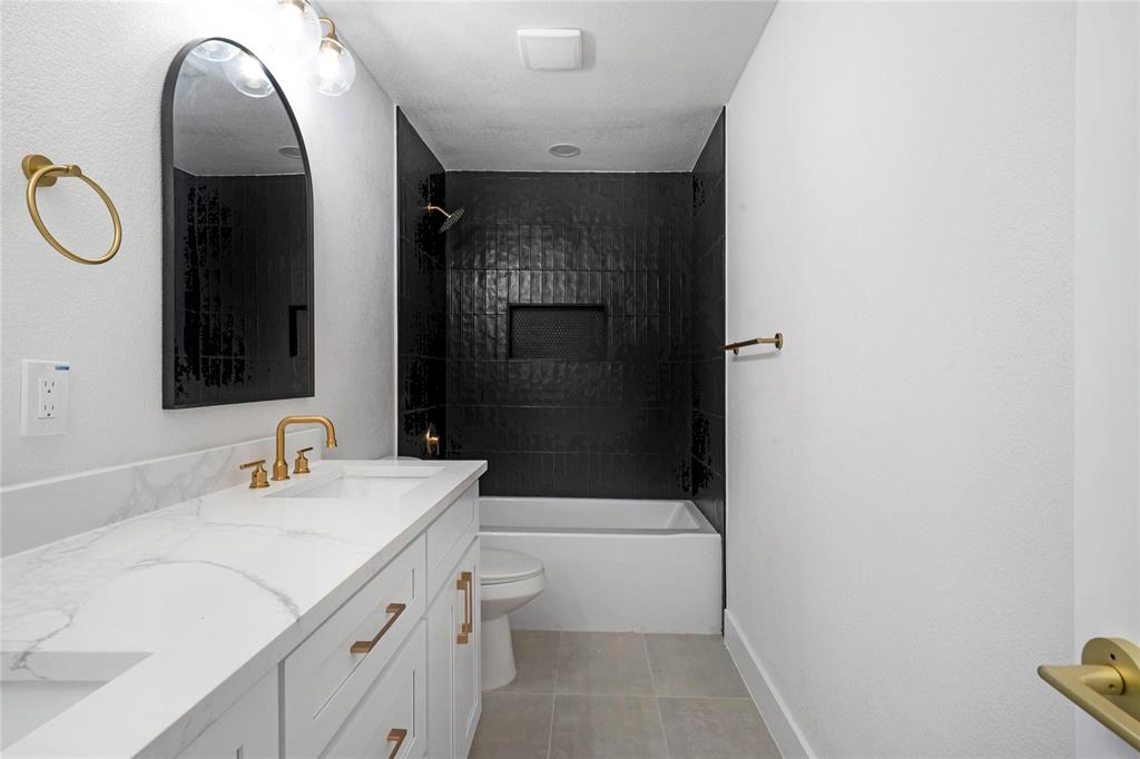 10416 Church Road Dallas, TX 75238 - Photo 21 of 36 a bathroom with a sink a toilet and shower