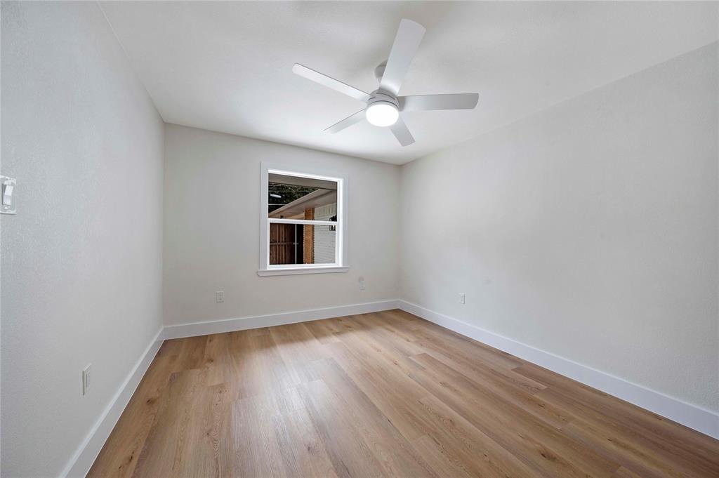10416 Church Road Dallas, TX 75238 - Photo 22 of 36 wooden floor in an empty room with a window
