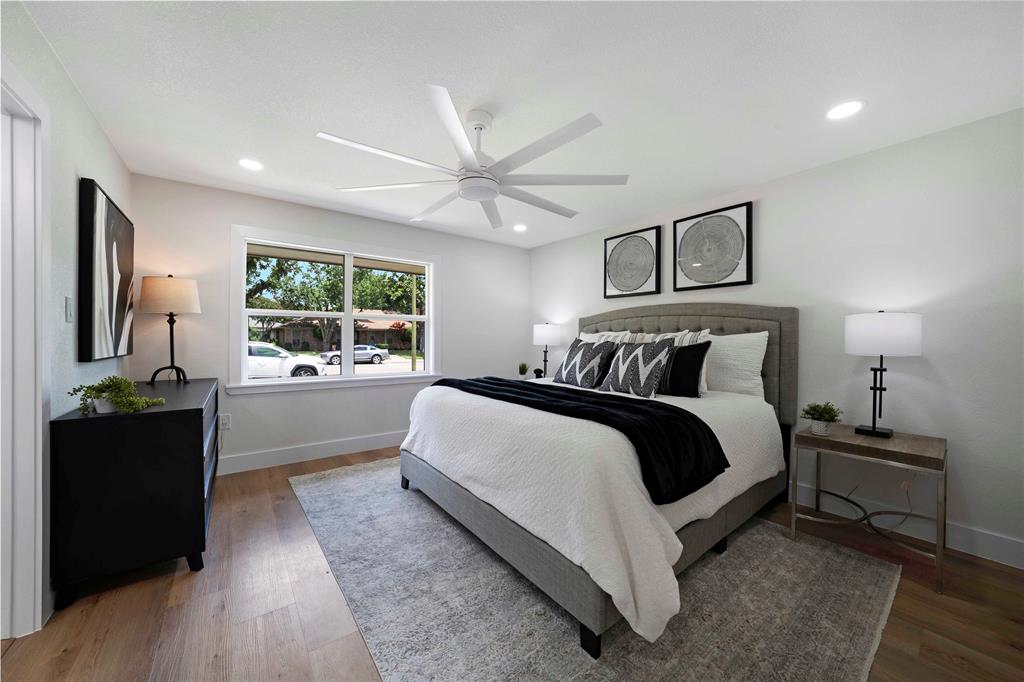 10416 Church Road Dallas, TX 75238 - Photo 23 of 36 a bedroom with a bed and a large mirror