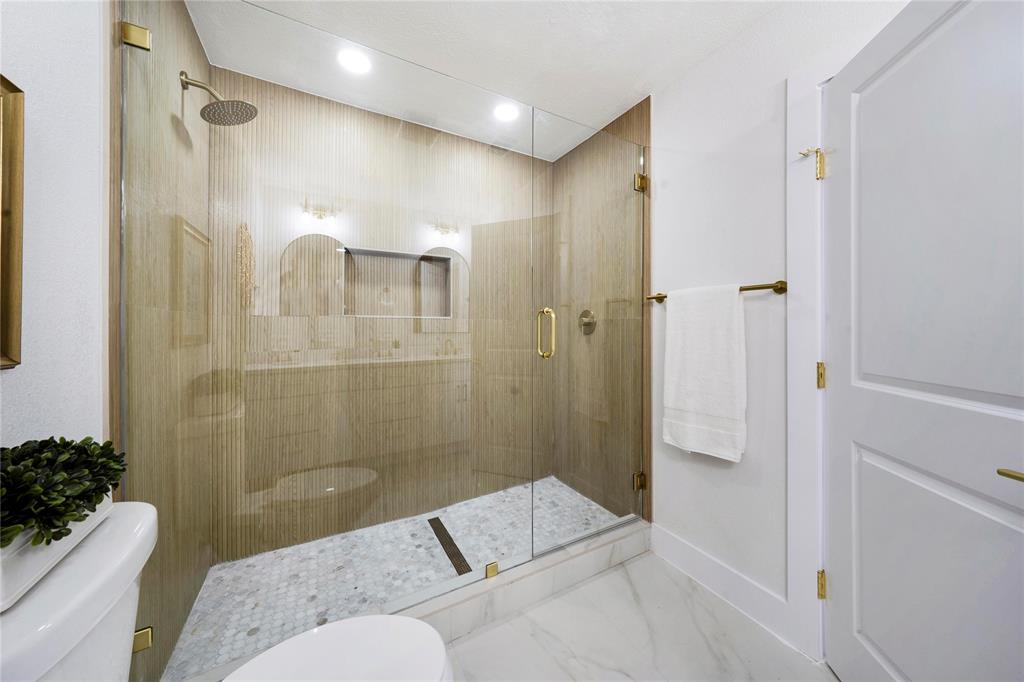 10416 Church Road Dallas, TX 75238 - Photo 28 of 36 a bathroom with a tub shower and sink