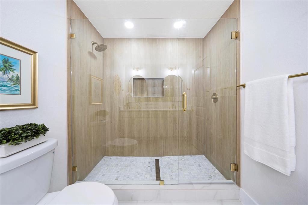 10416 Church Road Dallas, TX 75238 - Photo 31 of 36 a bathroom with a granite countertop sink toilet and shower