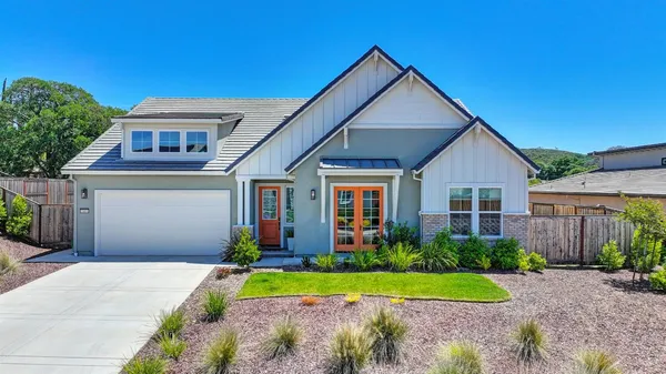 a front view of a house with a yard and garage