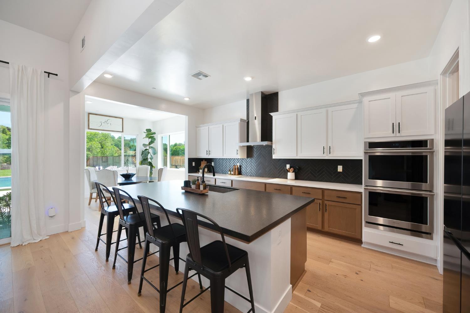 5085 Pryor Drive Rescue, CA 95672 - Photo 15 of 50 a kitchen with a table chairs stove and cabinets