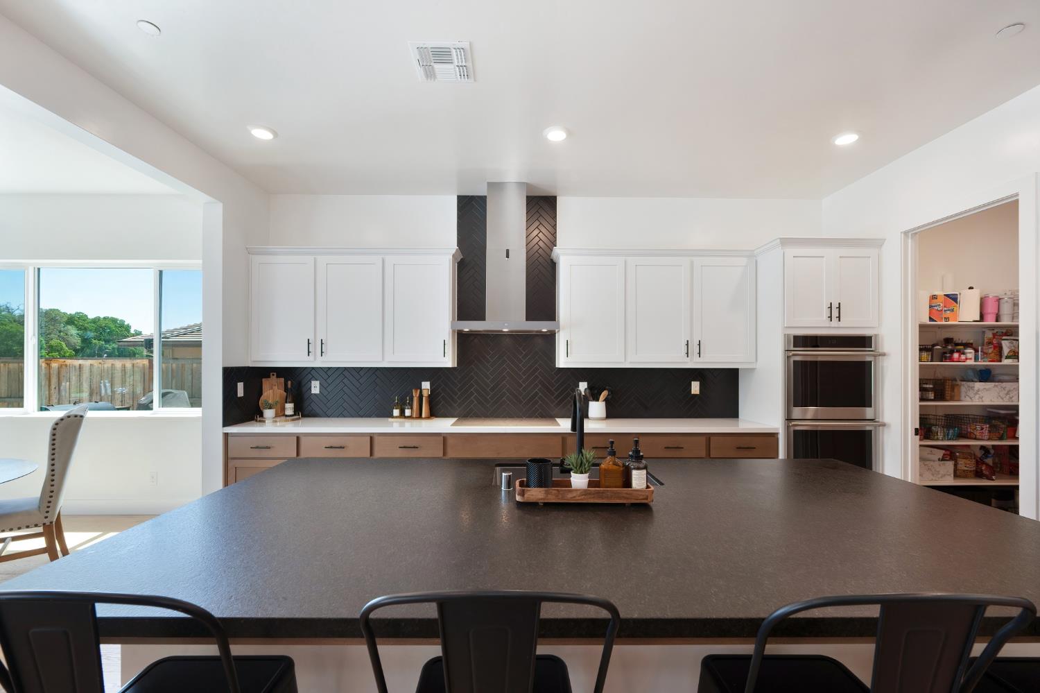 5085 Pryor Drive Rescue, CA 95672 - Photo 18 of 50 an open kitchen with dining table and chairs