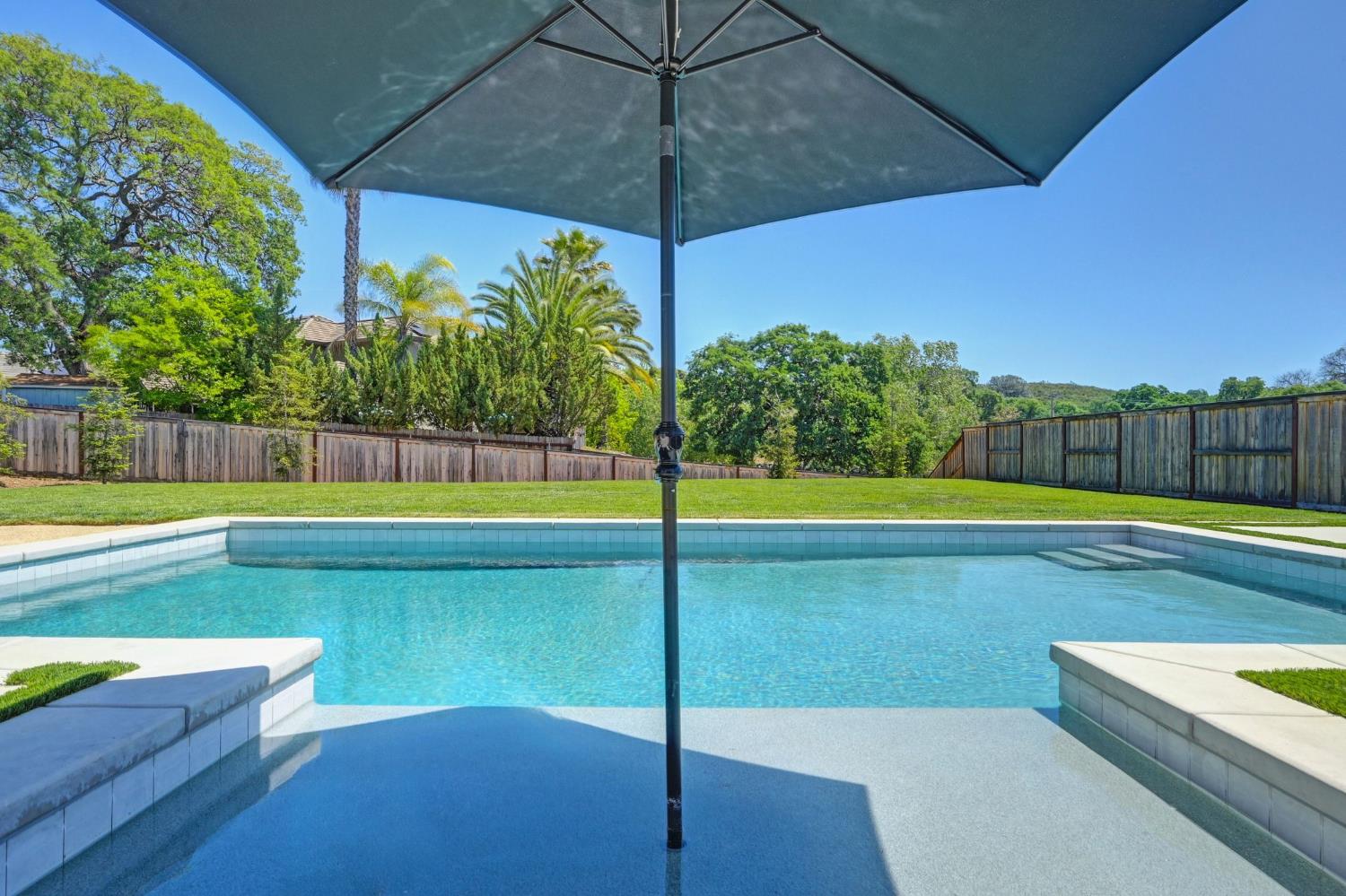 5085 Pryor Drive Rescue, CA 95672 - Photo 25 of 50 a view of a swimming pool with a chair and tables in the back yard