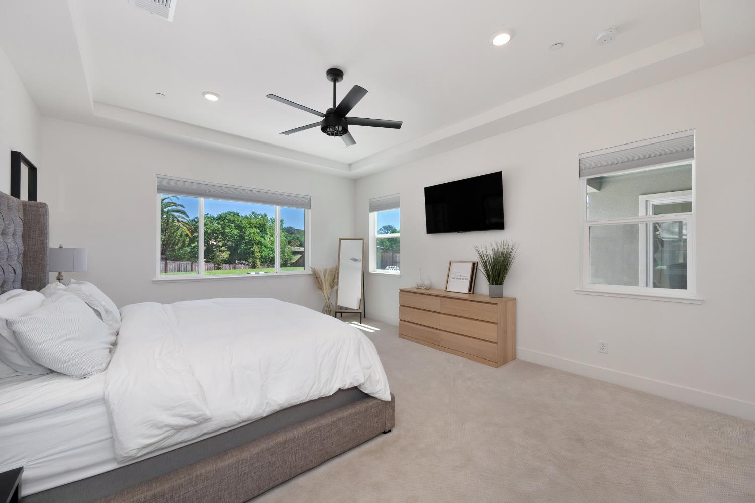 5085 Pryor Drive Rescue, CA 95672 - Photo 30 of 50 a bedroom with a large bed and a flat screen tv