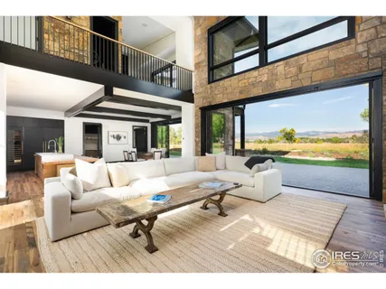 a kitchen with stainless steel appliances kitchen island granite countertop a table chairs in it and wooden floors