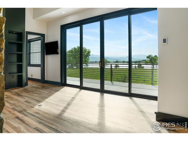 a bedroom with a bed and a balcony view