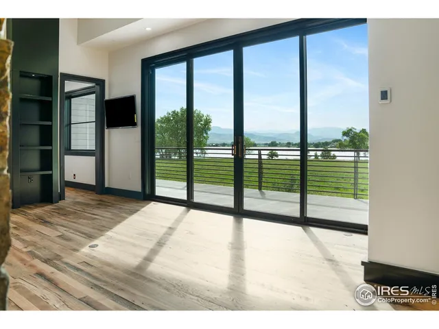 a bedroom with a bed and a balcony view