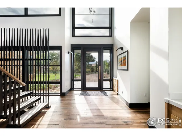 a living room with furniture a flat screen tv and a floor to ceiling window