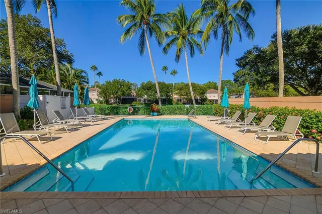 a view of a backyard with swimming pool