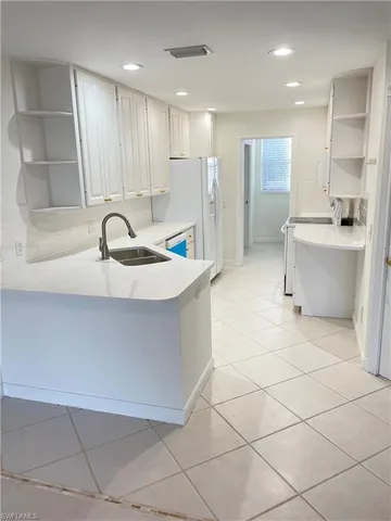 a large kitchen with kitchen island a sink a counter and a sink