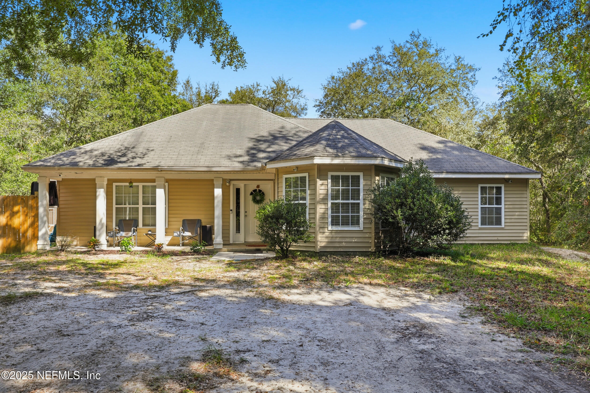 a view of a house with a yard and sitting area