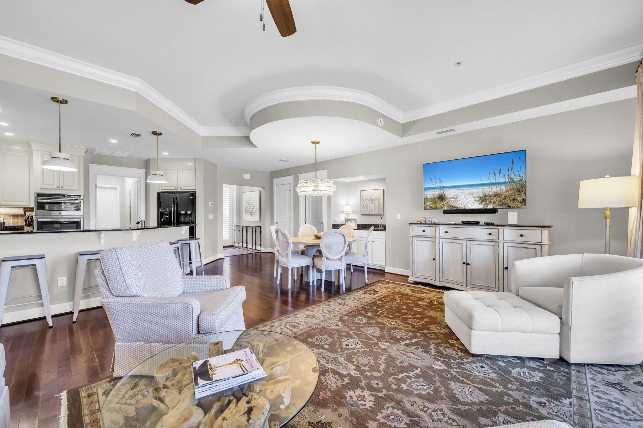 5360 Pine Ridge Lane, Unit 5360 Miramar Beach, FL 32550 - Photo 10 of 44 a living room with furniture a rug kitchen view and a chandelier