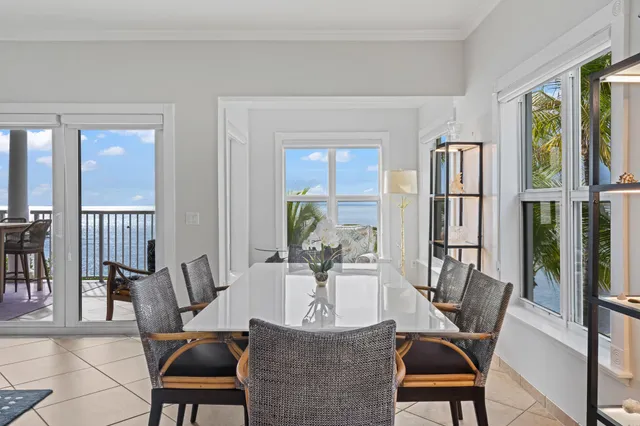 a bathroom with a toilet a large window and a shower