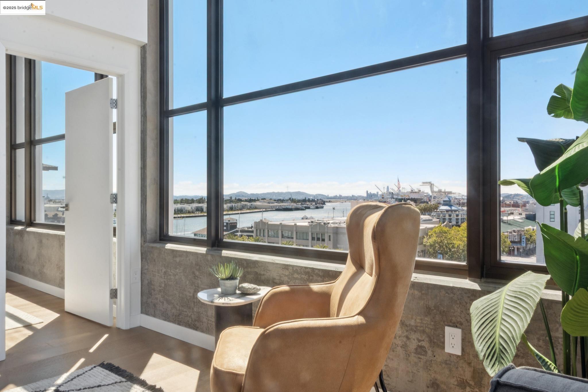 a dining room with furniture and a floor to ceiling window