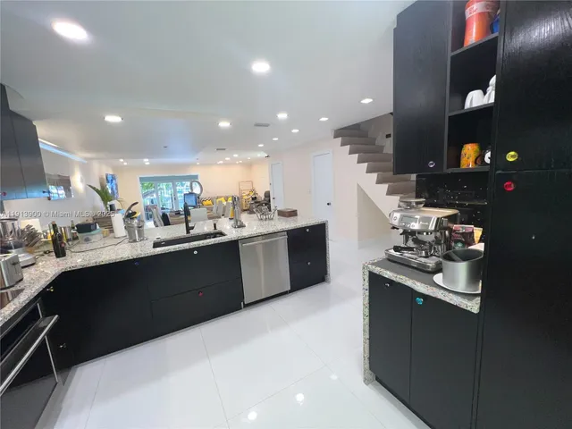 a kitchen with a sink a stove and cabinets