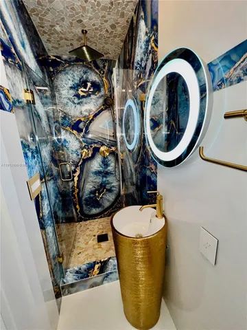 a room with water heater and wooden cabinets