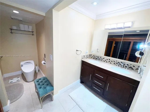 a spacious bathroom with a granite countertop sink a toilet and a mirror