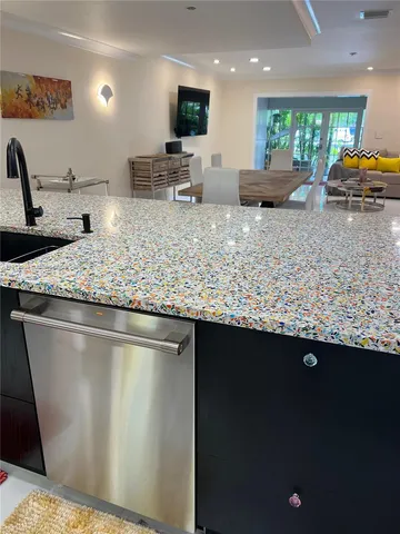 a kitchen with stainless steel appliances granite countertop a sink stove and a granite counter top
