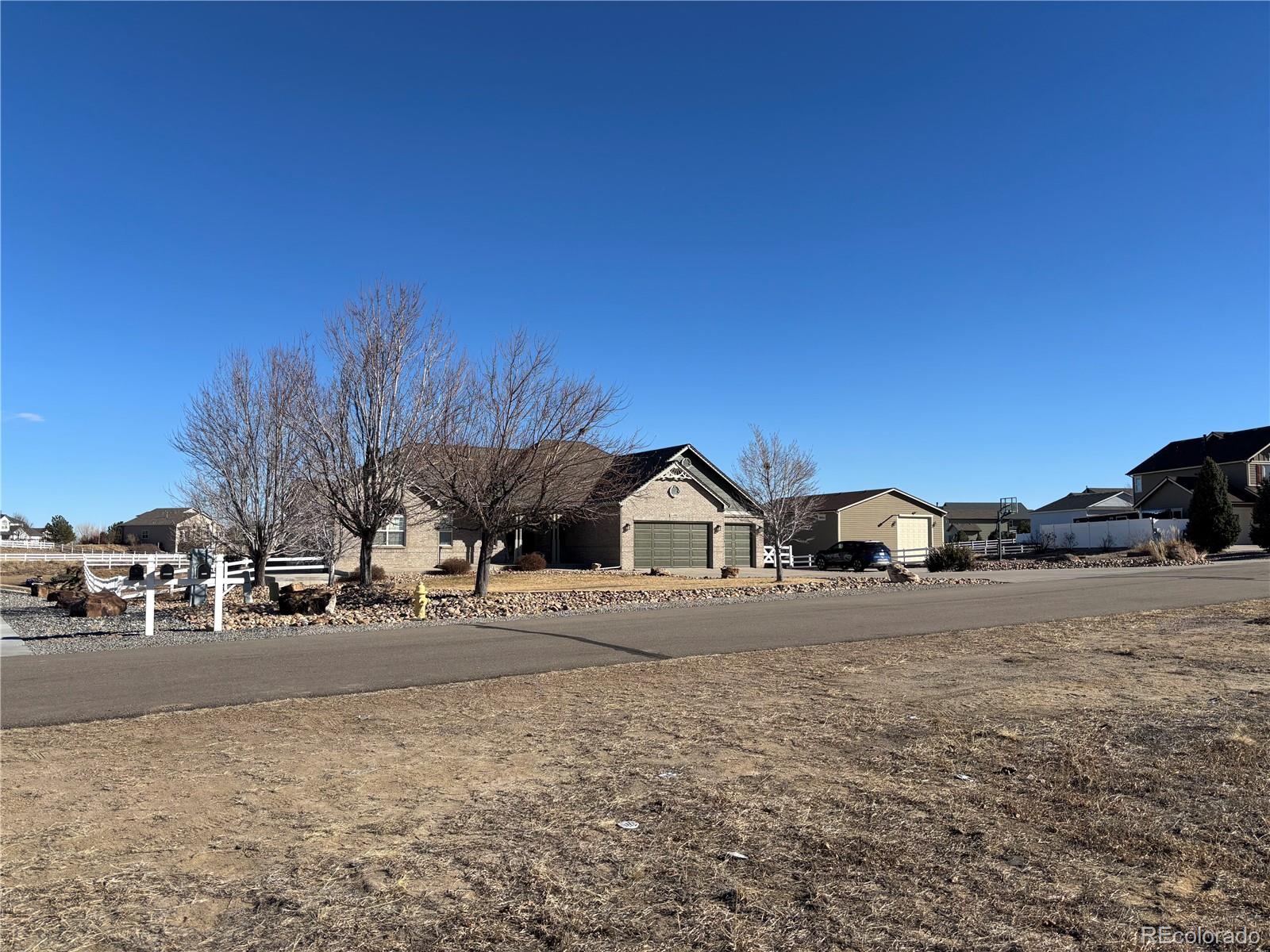 16495 Queensview Street Hudson, CO 80642 - Photo 3 of 9 a view of road with house and trees in the background