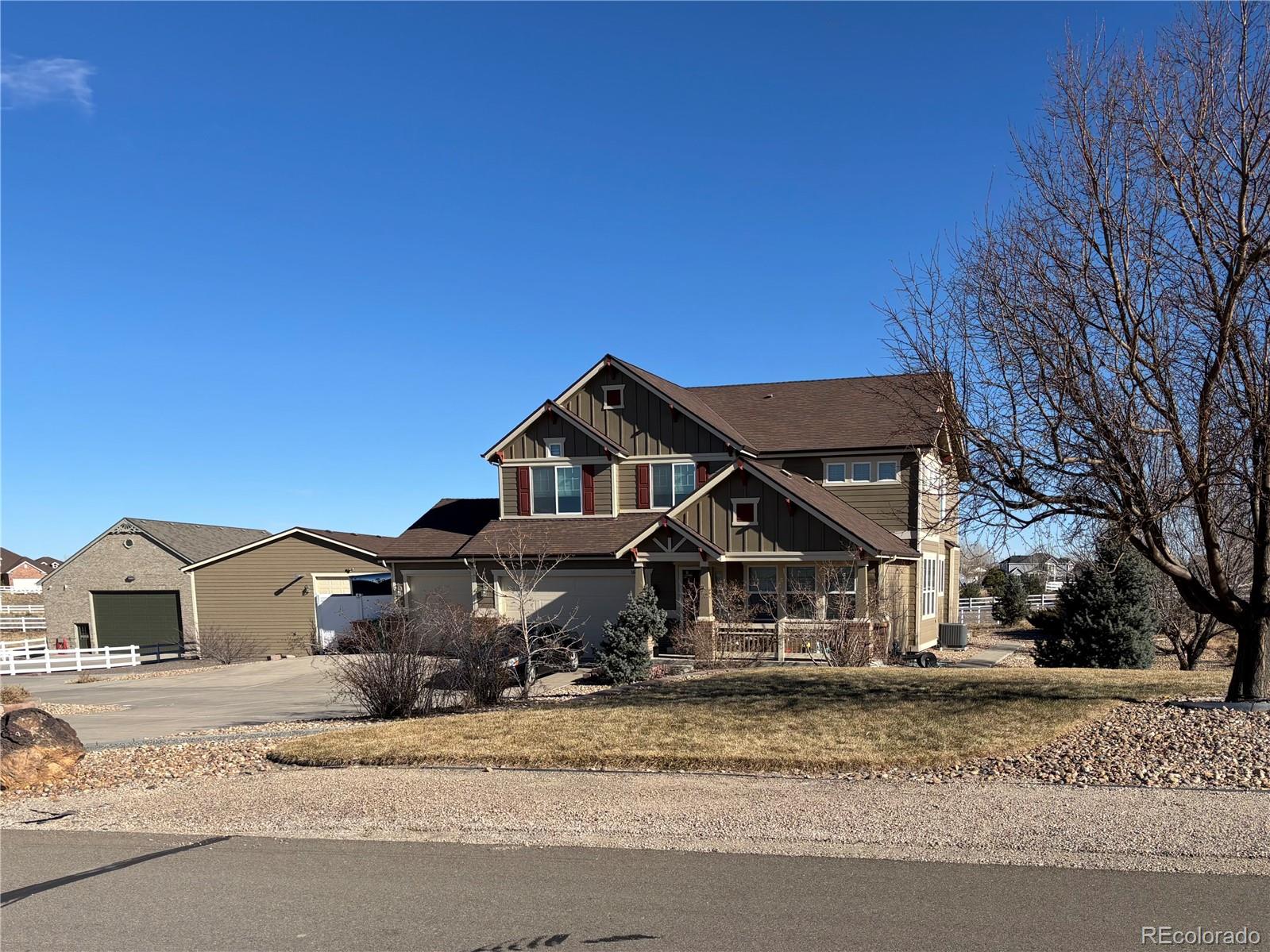 16495 Queensview Street Hudson, CO 80642 - Photo 4 of 9 a front view of a house with a yard