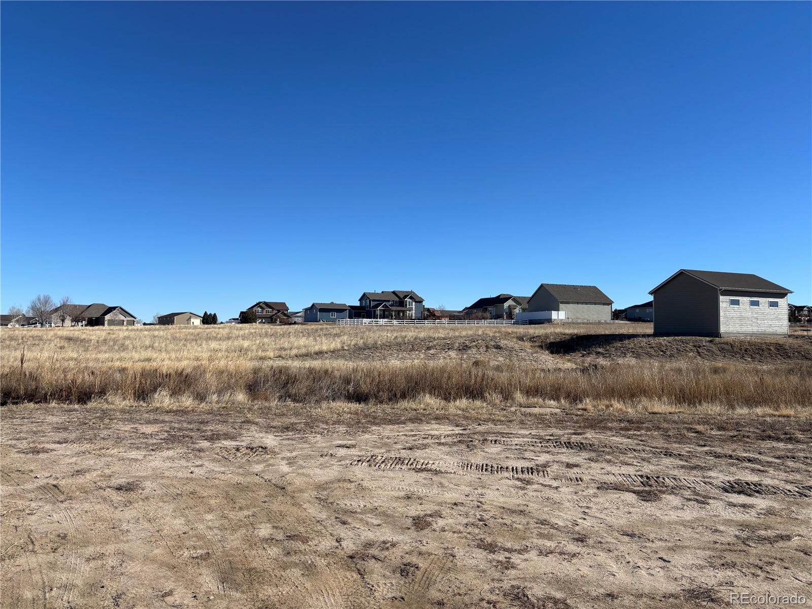 16495 Queensview Street Hudson, CO 80642 - Photo 8 of 9 a view of a large body of water with a building in the background