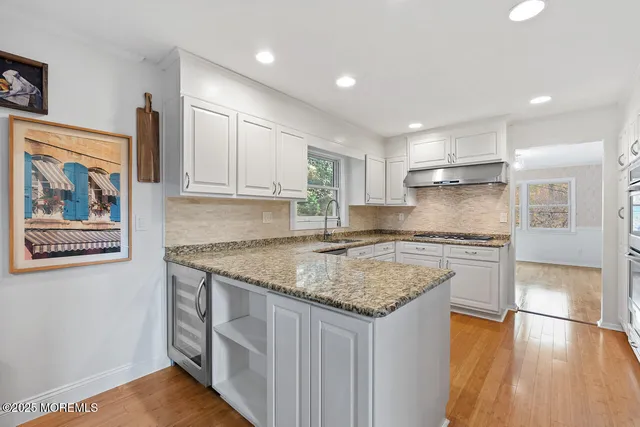 a kitchen with stainless steel appliances granite countertop a stove and a sink