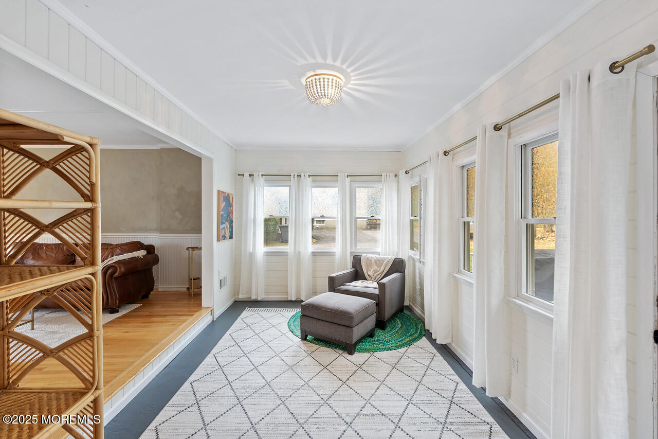 349 River Road Fair Haven, NJ 07704 - Photo 16 of 49 a living room with furniture and a floor to ceiling window
