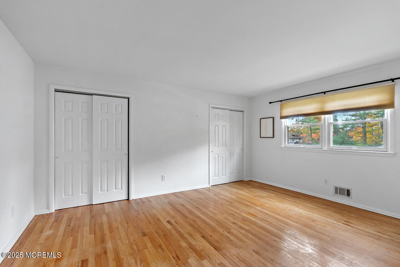 349 River Road Fair Haven, NJ 07704 - Photo 27 of 49 a view of empty room with wooden floor and fan