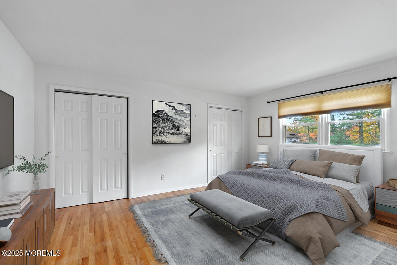 349 River Road Fair Haven, NJ 07704 - Photo 28 of 49 a bedroom with a large bed and a potted plant