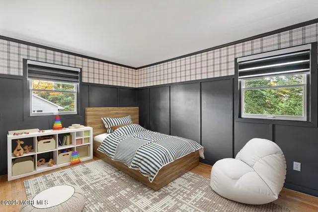 a bedroom with a bed and a large window