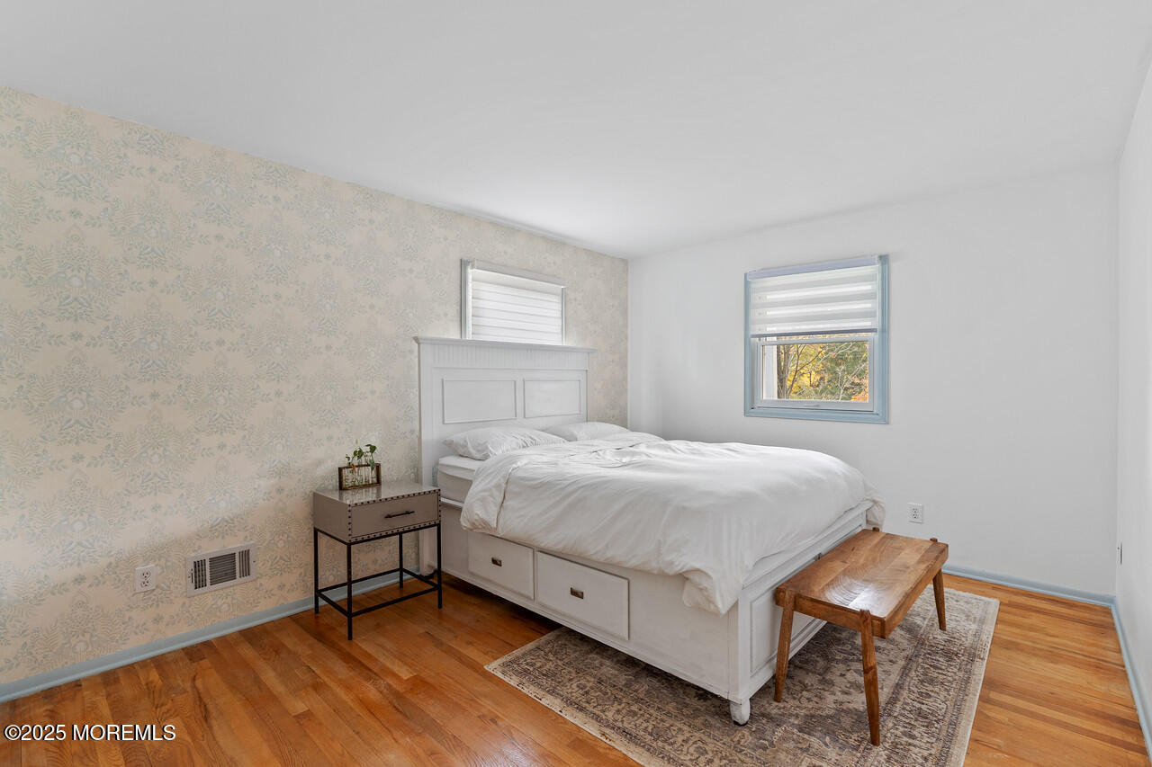349 River Road Fair Haven, NJ 07704 - Photo 35 of 49 a spacious bedroom with a bed and a window