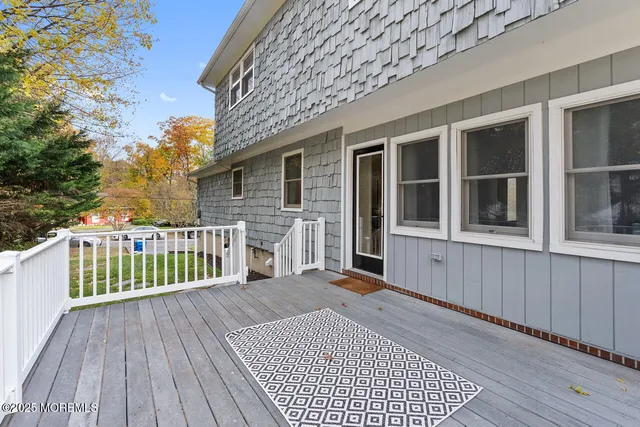 a view of a house with a yard and deck
