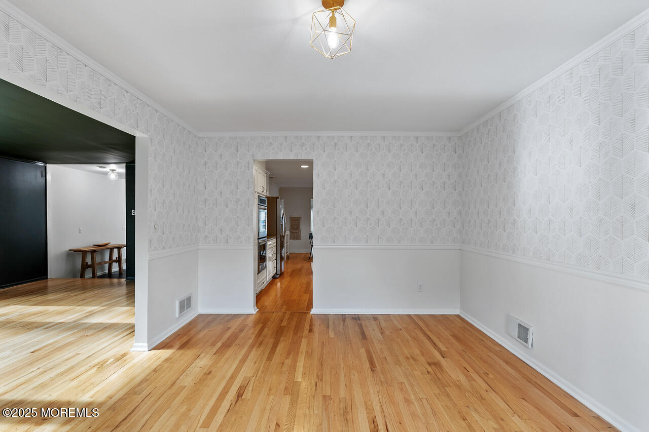 349 River Road Fair Haven, NJ 07704 - Photo 9 of 49 a view of a room with wooden floor and a ceiling fan