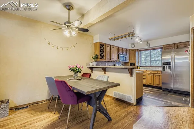 a view of a dining room with furniture and chandelier
